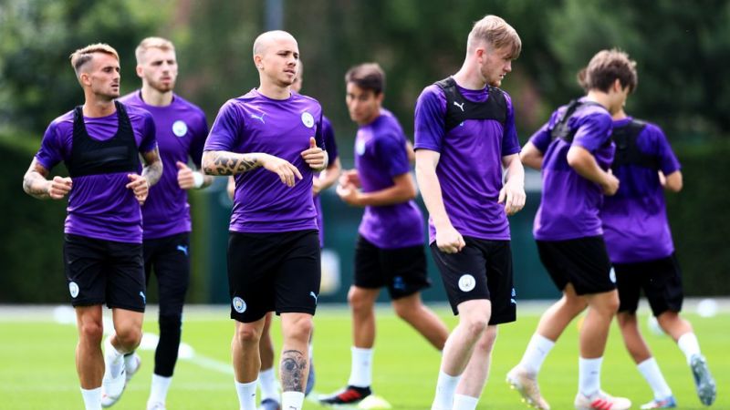 Manchester CIty's Pep Guardiola greets his players back to pre-season training